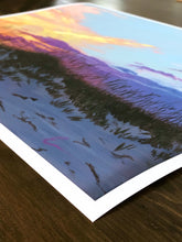 Load image into Gallery viewer, corner view of print of painting of peach, gold, and purple sunset in front of pale blue sky over darkening sand dunes with sea oats