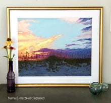 Load image into Gallery viewer, Matted and framed print of painting of peach, gold, and purple sunset in front of pale blue sky over darkening sand dunes with sea oats between vase of flowers and glass baubles